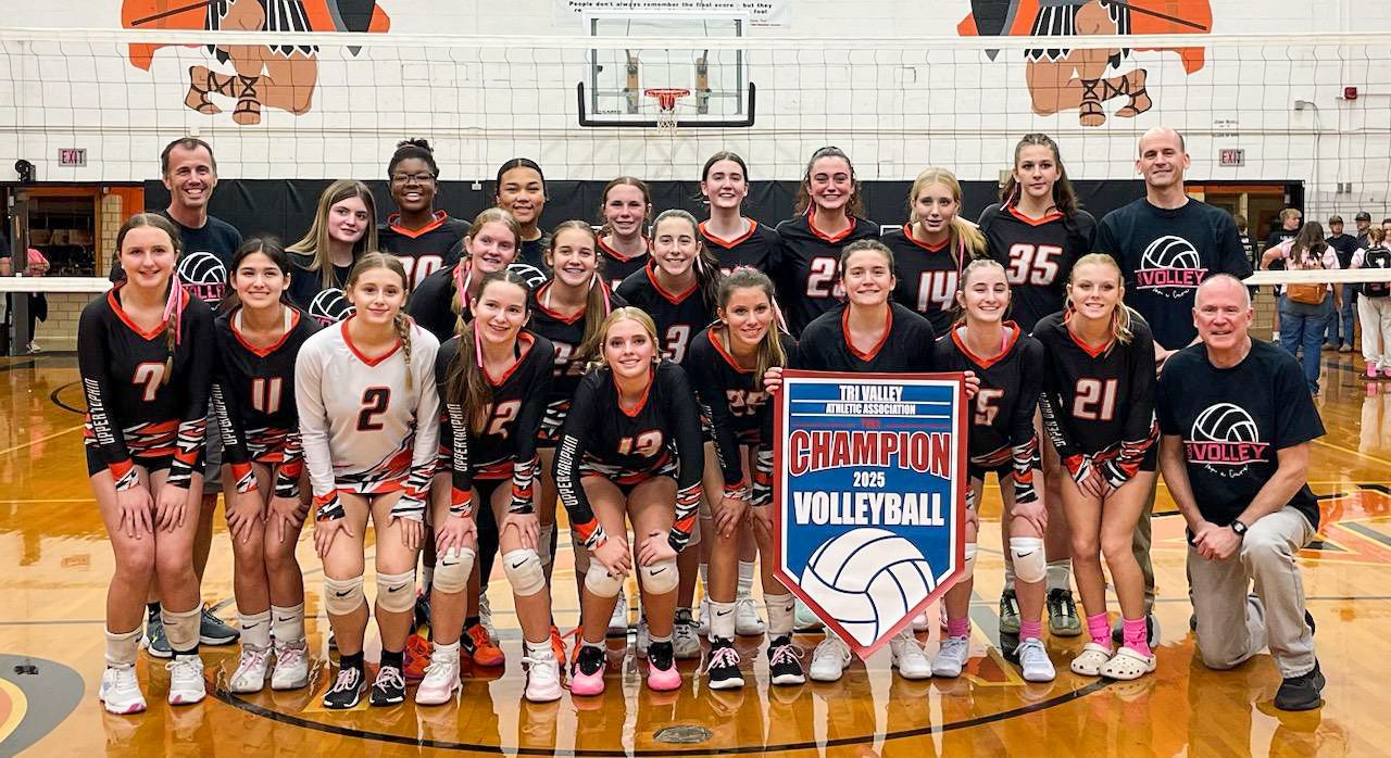 uda volleyball group photo holding the TVAA championship banner