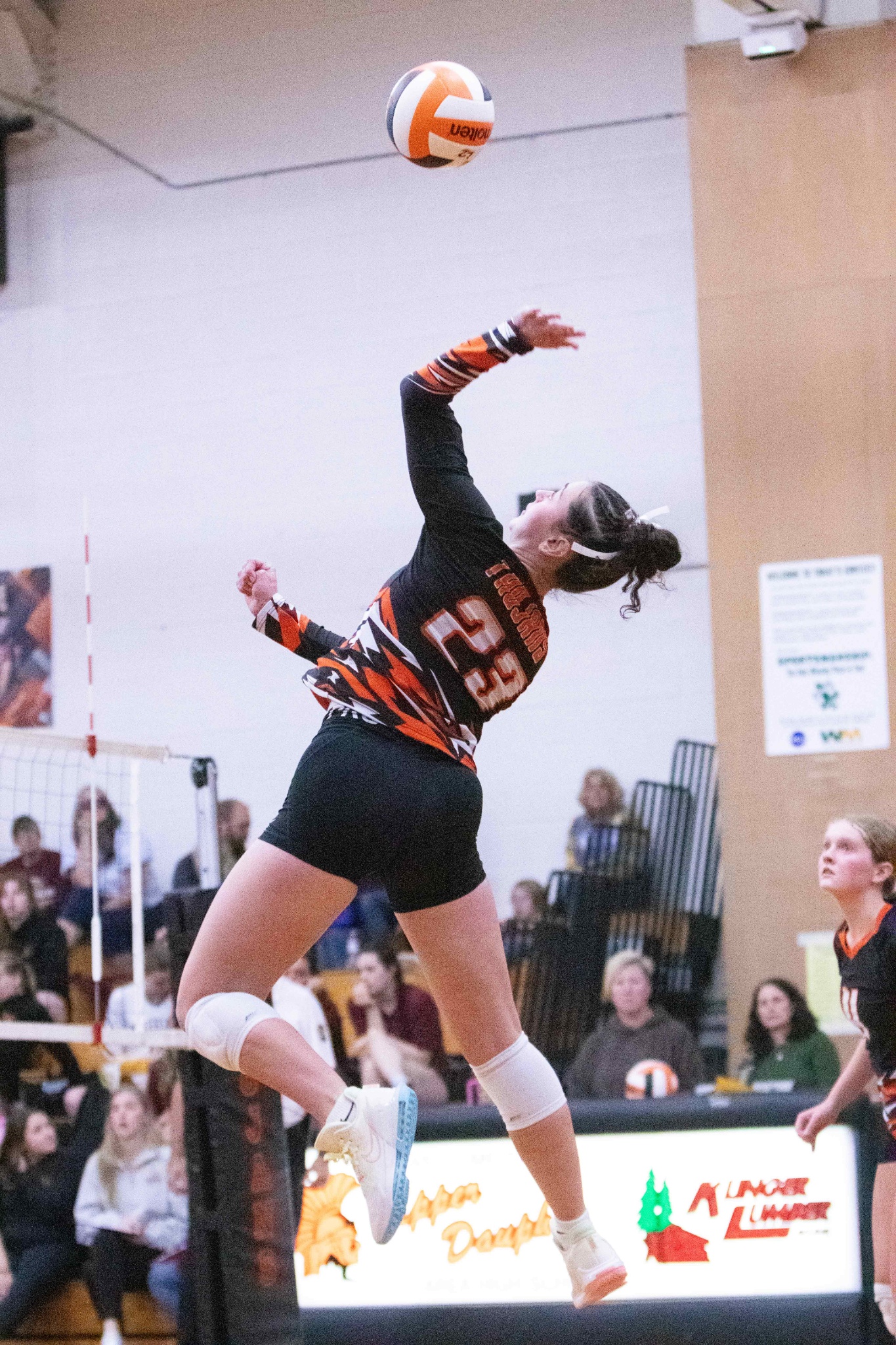 uda volleyball player spiking the ball