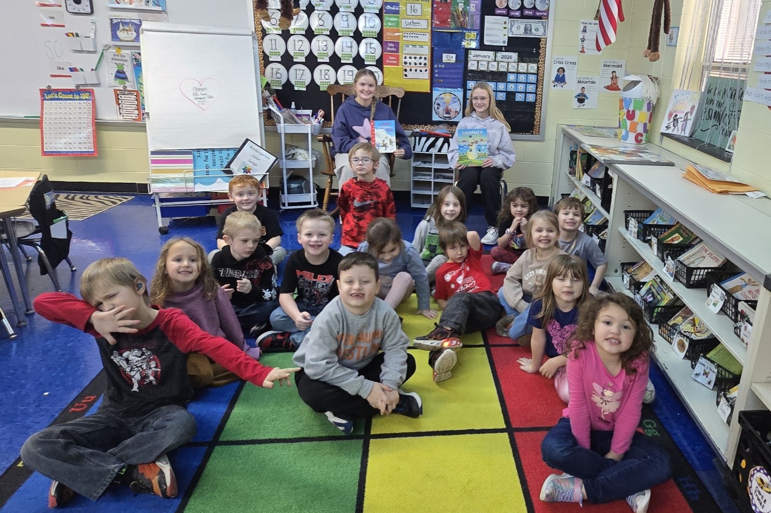 elementary kids posing with their middle school student readers