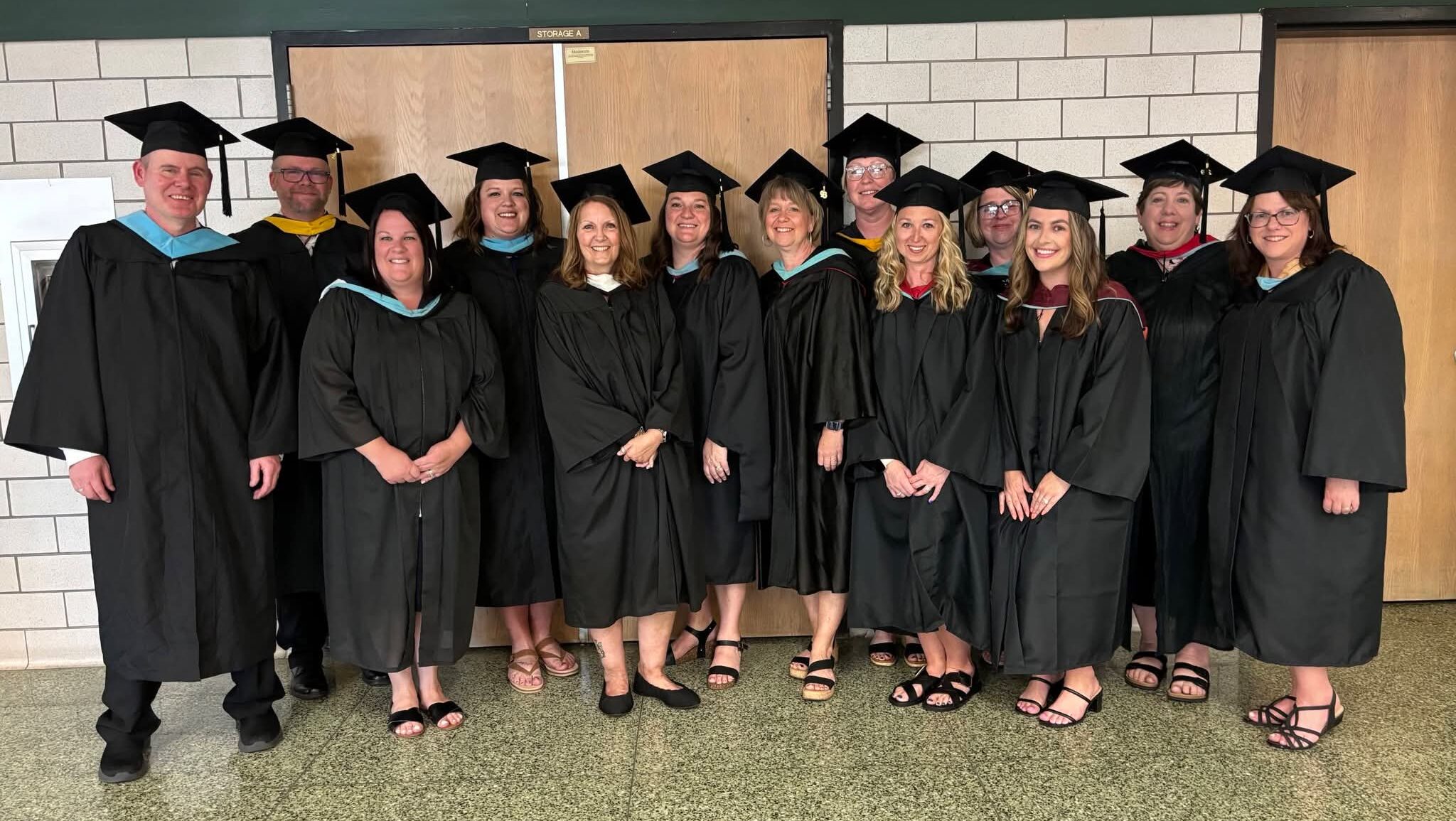 Elementary Faculty Grad 2026 group of faculty in graduation caps and gowns